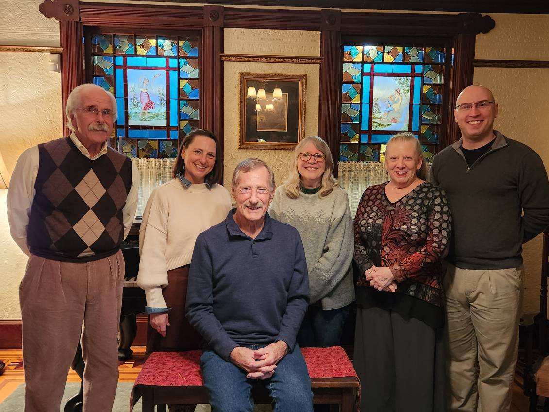 six smiling people looking at the camera