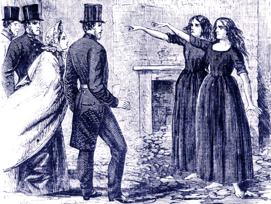 three men in top hats and coattails and a woman in a shawl stand opposite two women in dark dresses and unbound hair